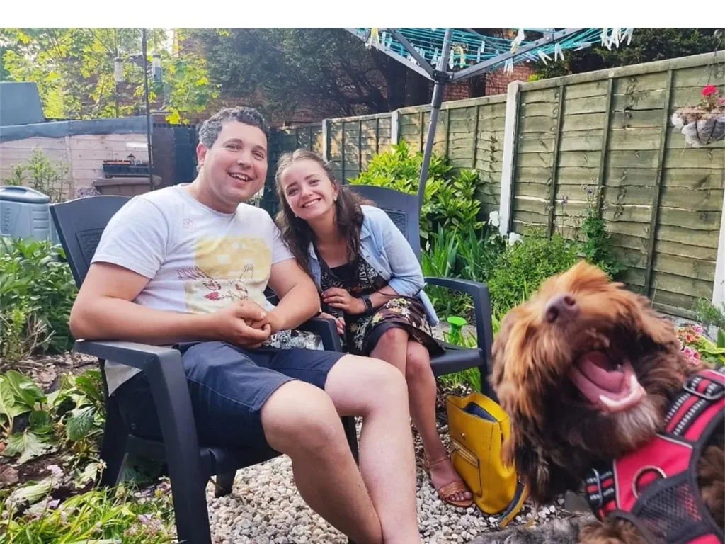 a person sitting on a bench with a dog
