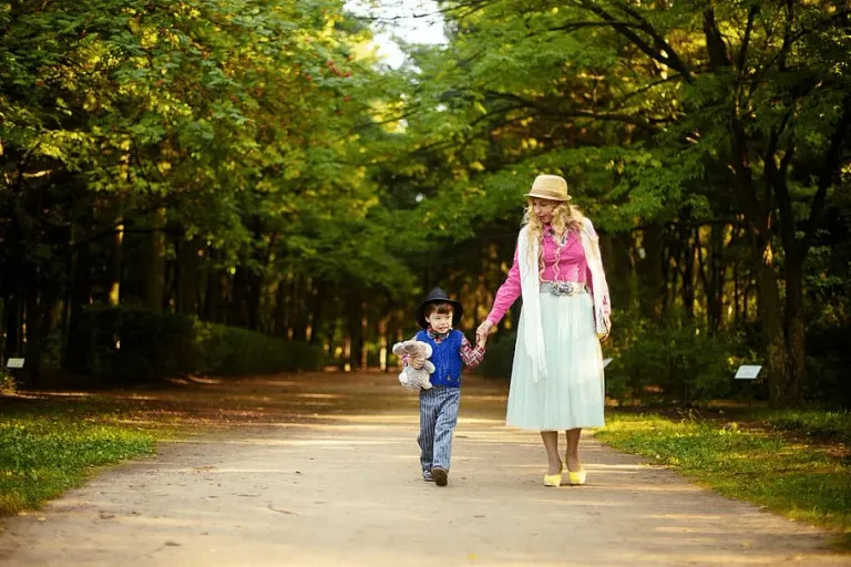 a little girl standing in a park
